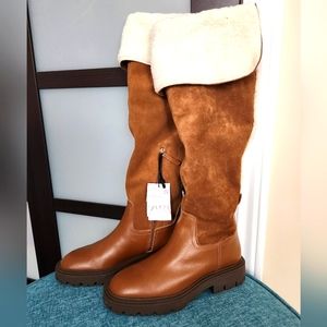 Knee-High Leather Boots with contrast faux shearing interior.